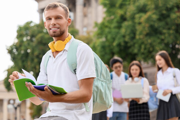 Canvas Print - Male student with copybooks near university