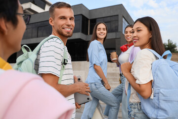 Poster - Group of young students smiling near university