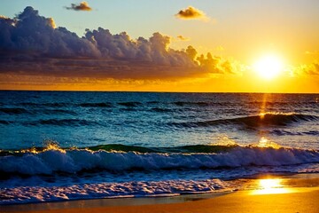 The sun sets over the calm ocean waves, with the sandy beach in the foreground