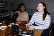 © Oleksii Syrotkin/Stocksy - Flash photo of plus size podcasters creating content at home studio