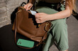 © Amor Burakova/Stocksy - Woman Getting Out Credit Card From Brown Leather Handbag
