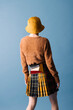 © Ulas&Merve/Stocksy - Stylish Woman In Fashion Outfit Back View On Blue Background