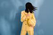 © Ulas&Merve/Stocksy - Stylish Woman In Yellow Suit Holding Fashionable Handbag