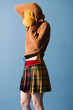 © Ulas&Merve/Stocksy - Stylish Woman in Colorful Skirt and Sweater Posing Fashionably