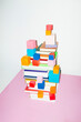 © Colour Laboratory/Stocksy - Colorful stack of books and geometry cubes and hard direct flashlight