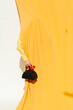 © Ulas&Merve/Stocksy - Fashionable Handbag and Yellow Fabric in Modern Composition