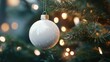 © Business Pics - Christmas white glossy round bauble ornament on christmas tree with decoration and blurred bokeh lights background.