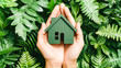 © NORN - Eco-Conscious Living: Hands cradle a miniature green home amidst lush foliage, symbolizing environmental protection and sustainable housing solutions.