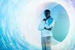 © VICTOR TORRES/Stocksy - Futuristic portrait of black man against circular light design