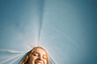 © Serge Filimonov/Stocksy - Smiling woman under blue sky - Carefree
