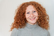 © Luis Velasco/Stocksy - Portrait Of Happy Woman With Curly Red Hair Smiling.