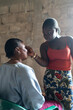 © Alvaro Lavin/Stocksy - Young woman applying makeup to senior woman in senegal, africa