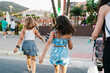 © Ezequiel Giménez/Stocksy - Girls Exploring Evening Market