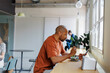 © BONNINSTUDIO/Stocksy - Man enjoys a healthy lunch while checking his phone
