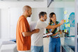 © BONNINSTUDIO/Stocksy - Creative team discussing project using sticky notes on glass wall