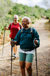 © BONNINSTUDIO/Stocksy - Two female friends hiking in nature on a sunny day