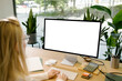 © Artem Podrez/Stocksy - Mockup Display with white screen Woman Working at Office Desk