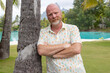 © Mat Hayward - Bald man with beard on a white sand beach while traveling on vacation on tropical island Bora Bora
