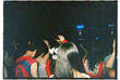 © Abigail Tulenko/Stocksy - Concert attendees wearing red shot on 35mm film