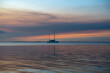 © John Holdmeier/Stocksy - Sailboat at sunset