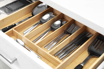 Wall Mural - Box with cutlery in drawer, closeup. Kitchen utensils storage