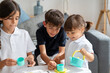 © mahalo studio/Stocksy - Three children enjoying tea party at home