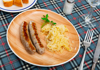 Wall Mural - Delicious fried sausage served with pickled cabbage on plate