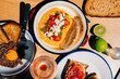 © Maria Sher/Stocksy - Gourmet Beef Tartar and Hummus Topped with Tomatoes