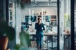 © Box Milk - A female CEO evaluating new product designs with her team. The room is filled with prototypes and creative discussions