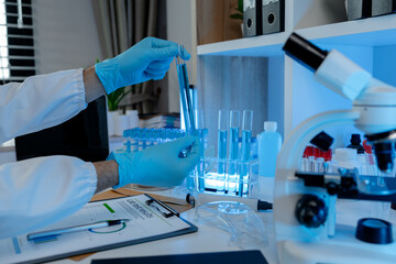 Wall Mural - a researcher is conducting scientific experiments on a liquid substance, a scientist is using labora