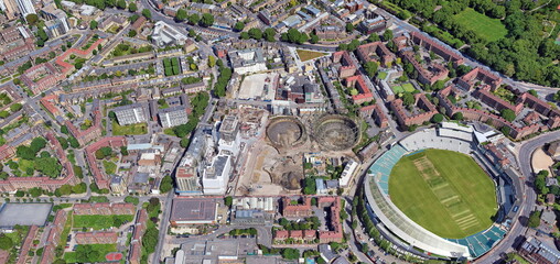 Photograph of the environmental impact on the outskirts of London, where houses, homes, sports stadiums coexist with waste, rubbish, ruins,