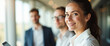 © Rysak - Portrait of a smiling businesswoman with colleagues in the background