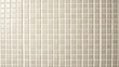© JJyce - Neutral-toned mosaic tiles arranged in a grid pattern. Perfect for design projects needing a geometric and organized texture, suitable for architectural or interior design concepts.