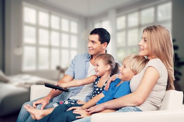 Wall Mural - Happy young family relaxing at home