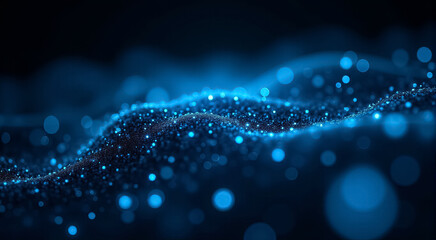 A close-up of shimmering blue particles creating a tranquil wave-like pattern in a dark atmosphere during nighttime