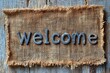 © sengah - Rustic welcome sign on burlap fabric background