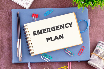 Conceptual emergency plan symbol. Copy space. Emergency plan words written in a notebook in a composition with office supplies, top view