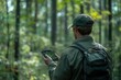 © ImagePulse - A forest ranger using GPS technology to monitor wildlife populations, symbolizing modern strategies in ecological protection