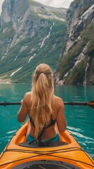 Poster - A woman enjoys kayaking in the breathtaking fjords of Norway, surrounded by towering mountains and tranquil waters