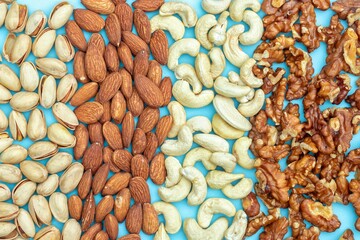 Wall Mural - Top View of Pistachio, Almond, Walnut and Cashew Nut Dry Fruits Background in Horizontal Orientation