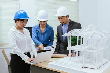 A team of architects and engineers work together in brainstorming sessions, discussing blueprints and construction plans for a real estate development.