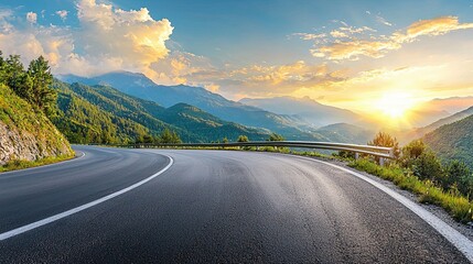 Wall Mural - beautifully curved asphalt road stretching through a scenic landscape at sunset. The road is bordered by lush green trees and mountains