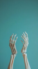 Two skeletal hands reaching upwards against a vibrant blue background.