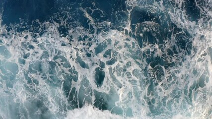 a mesmerizing top-down view of powerful ocean waves crashing and foaming against the shore, dynamic 