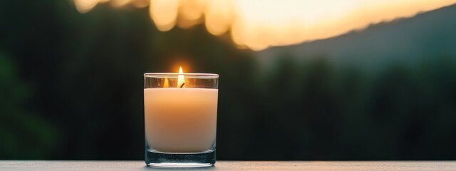 Sticker -  A candle atop a table, its wick aglow; a glass of water near, backdrop - a serene forest