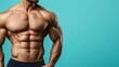 © Iswanto - A muscular man with a defined six-pack and toned arms stands against a bright turquoise background, showcasing his impressive physique.