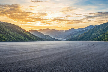 Empty asphalt road and beautiful mountain nature landscape at sunset. High quality photo