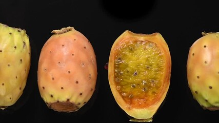 Canvas Print - Prickly pear cactus, Opuntia edible fruit macro shot. Fresh tasty sweet exotic fruits. Opuntia ficus indica isolated on black background, top view, flat lay, rotating