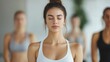 © Intelligent Horizons - Group of determined women engaged in intense hot yoga session their faces showing intense focus and beads of sweat as they push their bodies and minds to new levels of wellness and self discovery