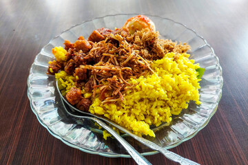 Yellow Rice on a plate on a wooden table